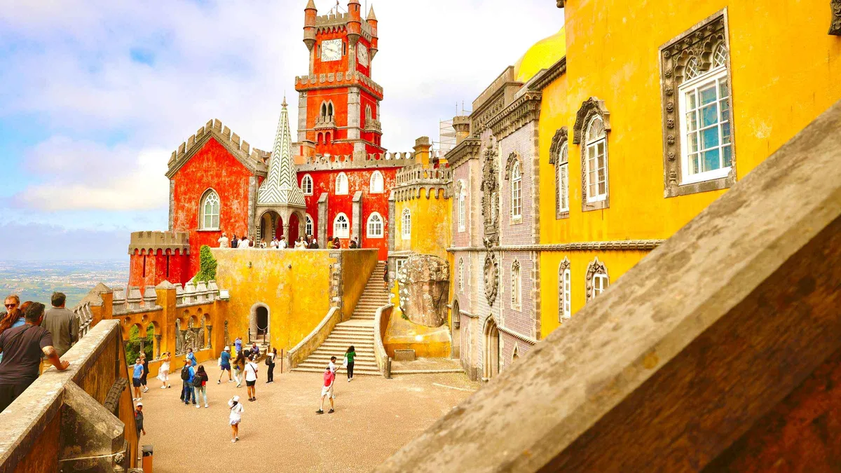 Red and yellow towers of Pena Palace on a Sintra, Pena, Cascais and Cabo da Roca day tour from Lisbon